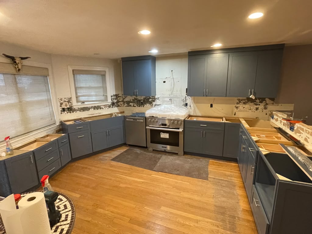 Slate blue kitchen cabinet installation in progress