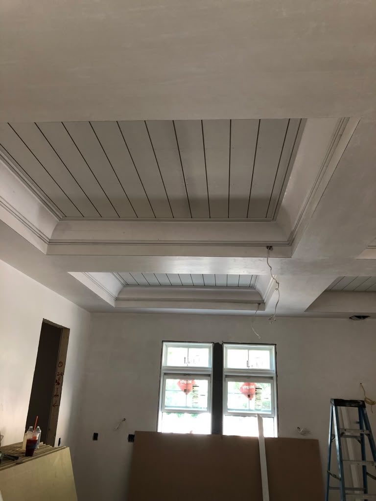 Tray ceiling with beadboard panels and layered crown molding by Supreme Remodeling